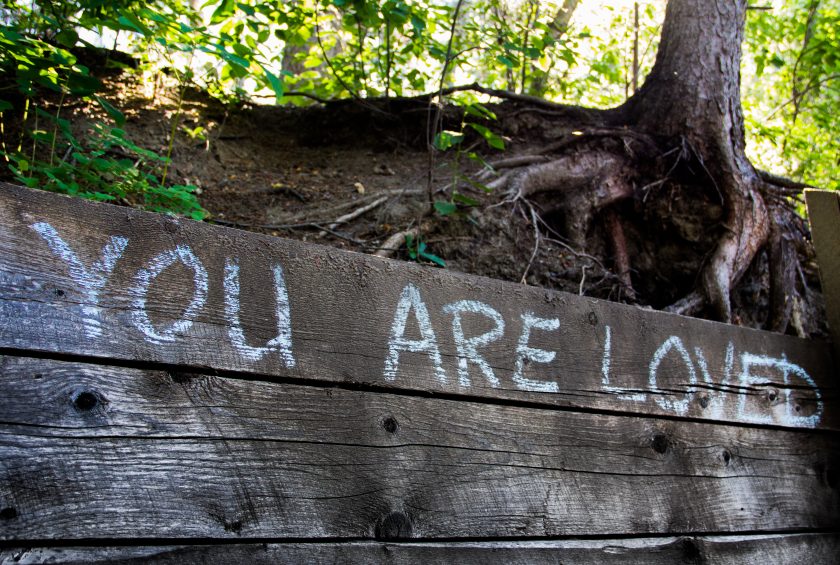 The words You Are Loved written on a wooden path